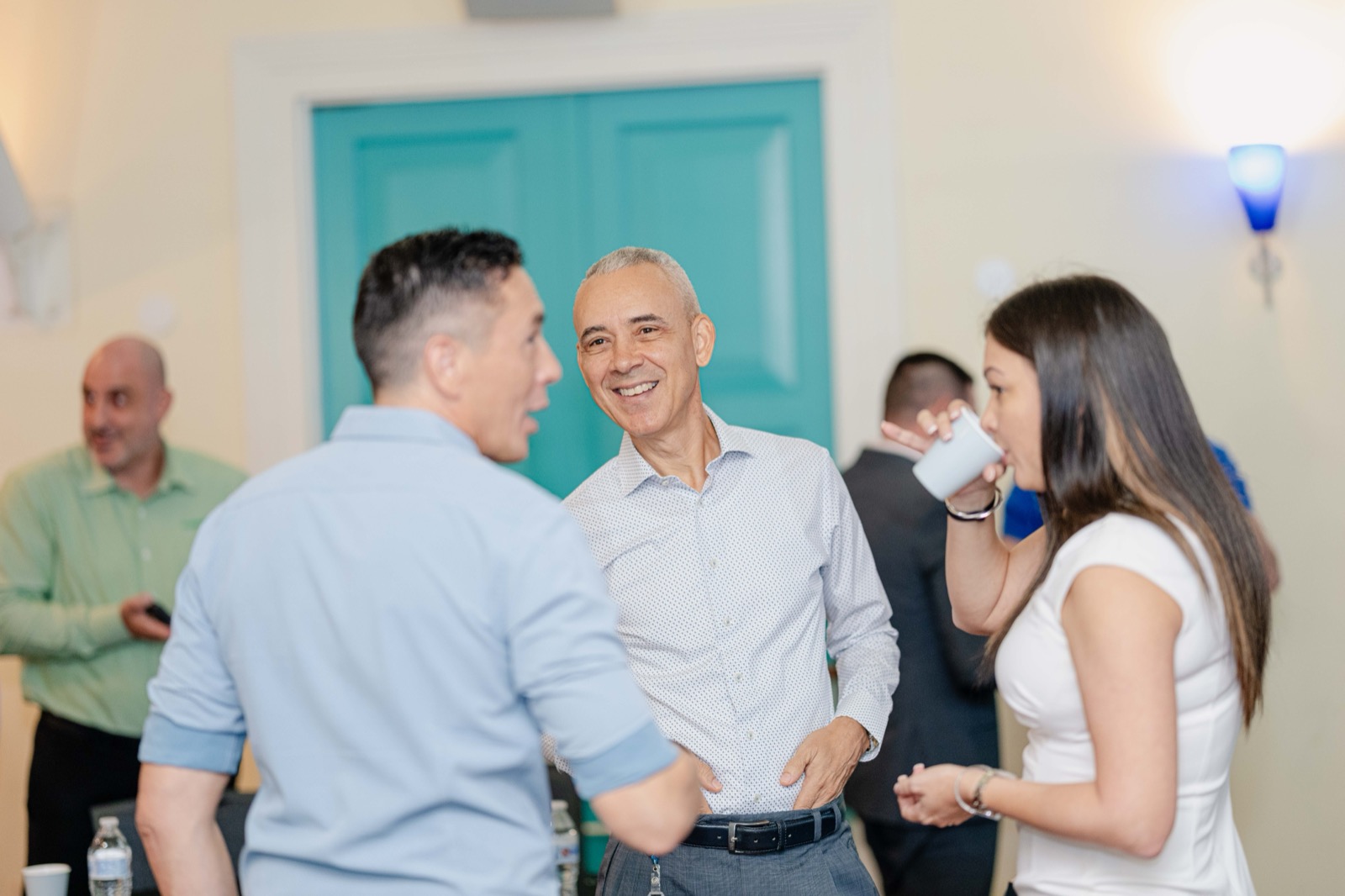 Group of three professionals chatting between sessions