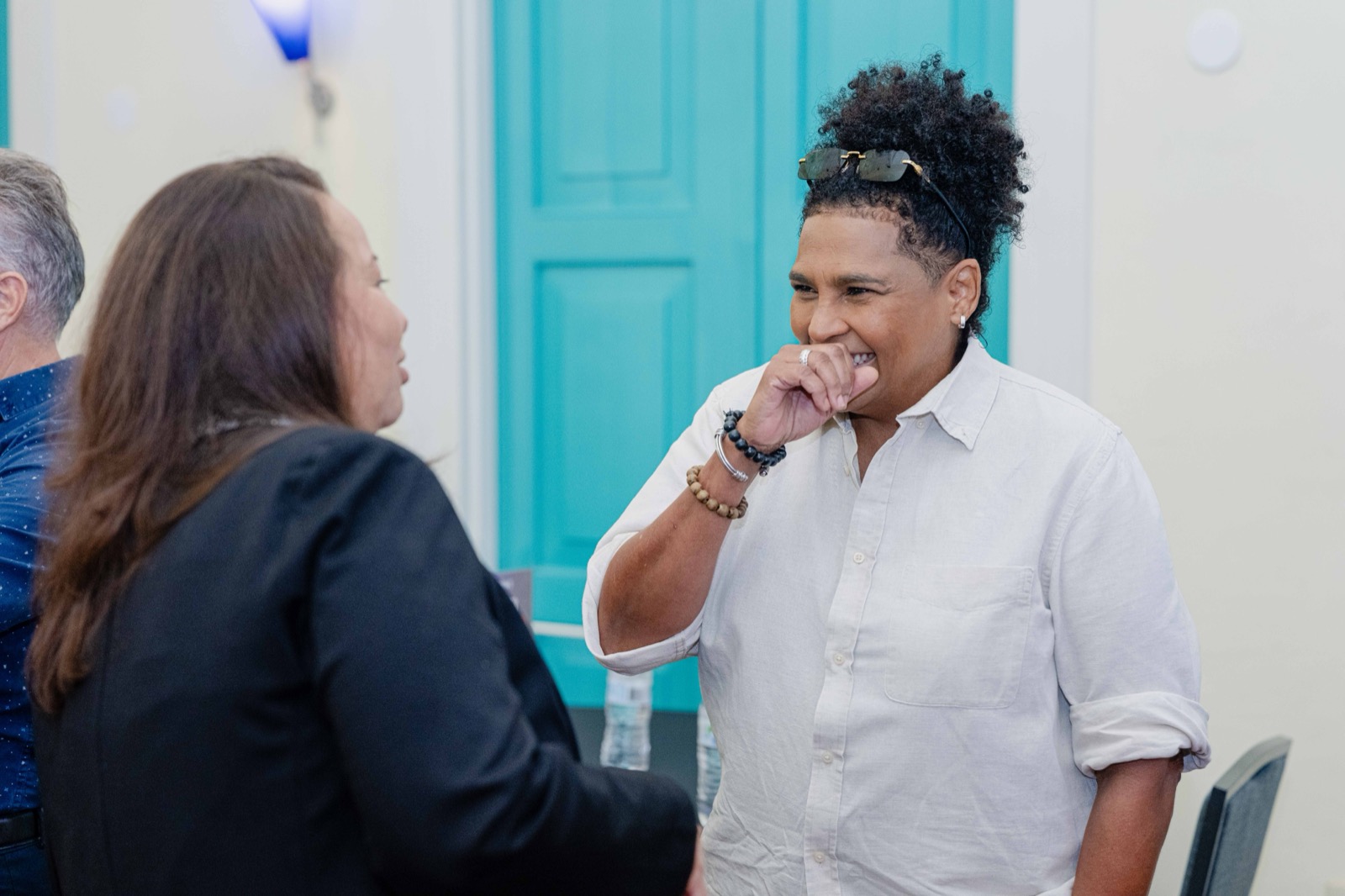 Two attendees networking and laughing